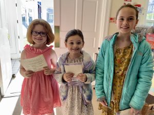 Young greeters were all smiles as they handed out bulletins